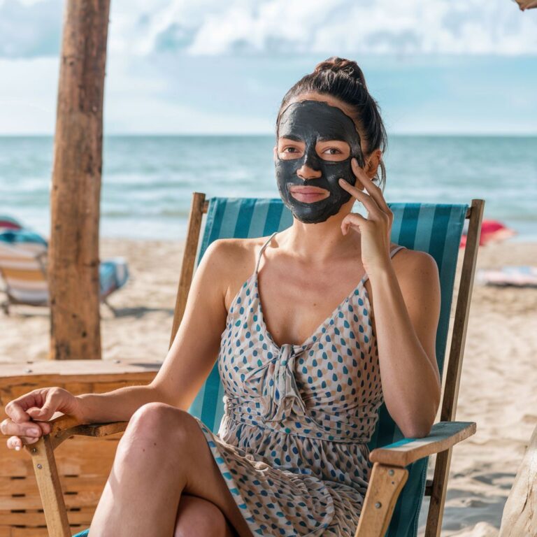 Women applying charcoal peel-off mask